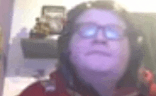 a man wearing glasses and headphones is making a funny face .