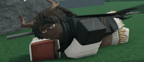 a video game character with horns is laying on the grass