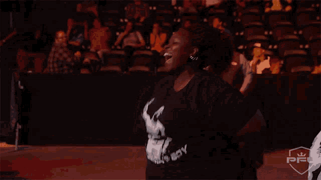 a woman wearing a black shirt that says cowboy on it
