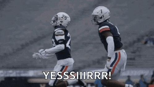 a couple of football players are running on a field and one of them is saying yes .