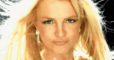 a close up of a woman 's face with blonde hair and earrings