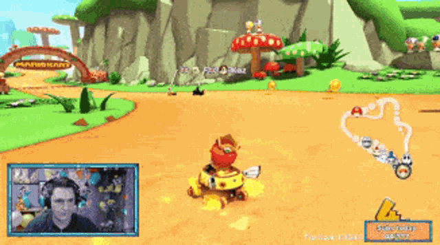 a man is playing a video game with a mario kart theme