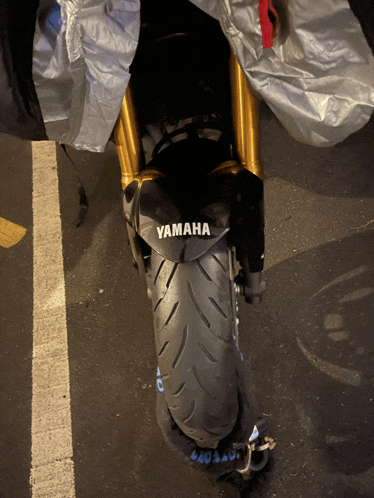 the front tire of a yamaha motorcycle is chained to the ground