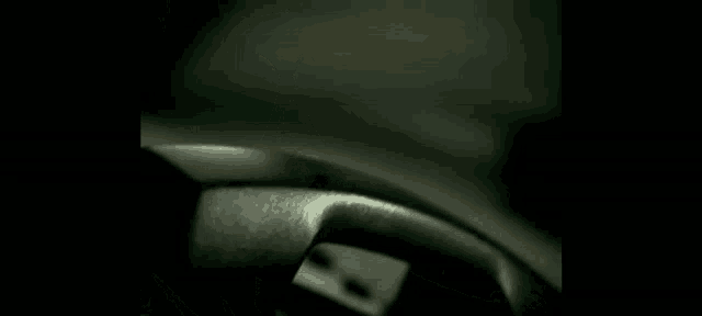 a close up of a steering wheel in a car in the dark