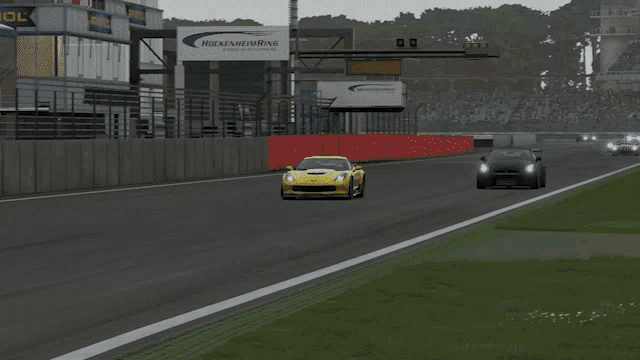 a yellow sports car is driving down a track