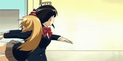 a couple of anime girls are standing next to each other and one of them is wearing a hat .