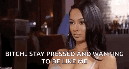 a woman is sitting at a table in a restaurant and saying `` bitch . stay pressed and wanting to be like me ''