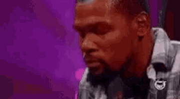 a man with his eyes closed is wearing a white jacket .