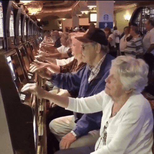 an elderly couple playing a slot machine with a starbucks sign in the background