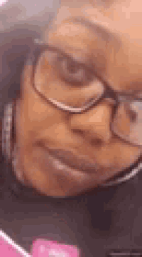 a close up of a woman wearing glasses and headphones .