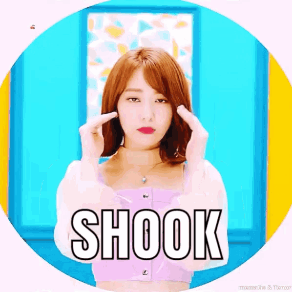 a woman in a pink top is making a heart with her hands and the word shook is on the bottom of the picture .