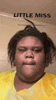 a woman in a yellow shirt is making a face .