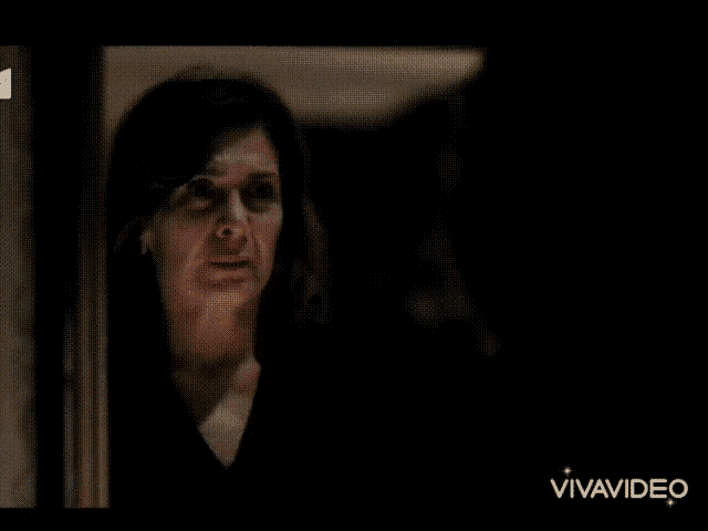 two women are looking at each other in a dark room and the words vivavideo are on the bottom of the screen