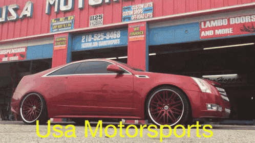a red car is parked outside usa motorsports