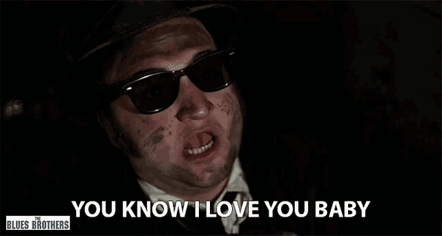 a man wearing sunglasses and a top hat says you know i love you baby
