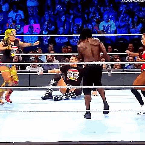 a group of wrestlers are fighting in a ring .