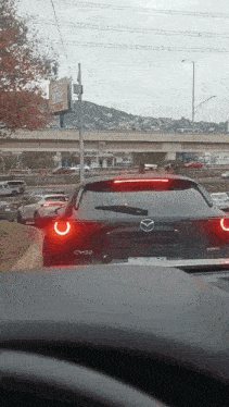 a mazda cx-30 is driving on a highway