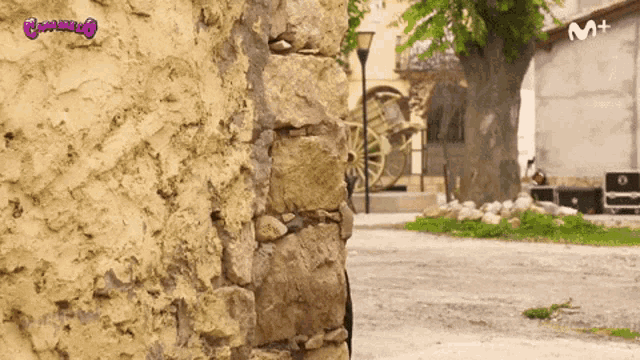 a stone wall with the letters m + on the bottom right