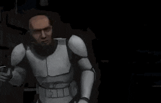 a clone trooper is standing in a dark room with his arms outstretched and looking at the camera .