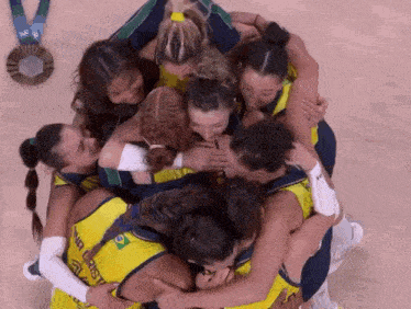 a group of women hugging with one wearing a yellow jersey that says rio cristo