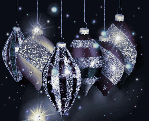 a bunch of christmas ornaments hanging from a string on a dark background