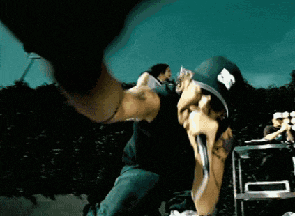 a man wearing a hat with the letter p on it is holding a microphone