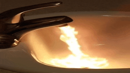 a sink with a faucet that is turned on
