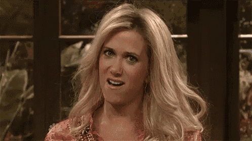 a man with blonde hair is making a surprised face
