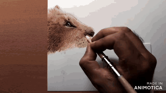 a person is drawing a lion with a brush and the words made in animotica are on the bottom