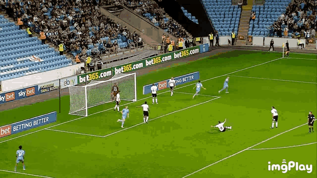 a soccer game is being played on a field with ads for bet365.com