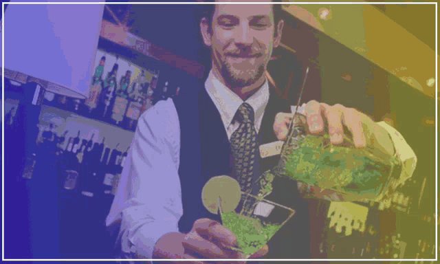 a bartender is pouring a drink into a glass