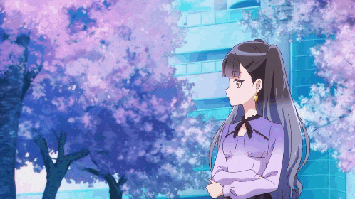a girl in a purple shirt is standing in front of a tree with pink flowers