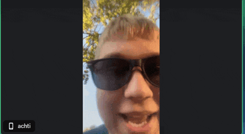 a close up of a man wearing sunglasses with the word echti on the bottom