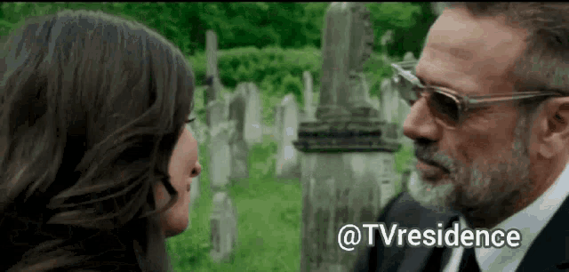 a man and a woman are looking at each other in a cemetery with the words @tvresidence written below them