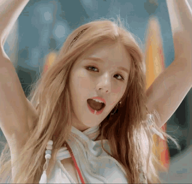 a close up of a woman with her mouth open and her arms in the air