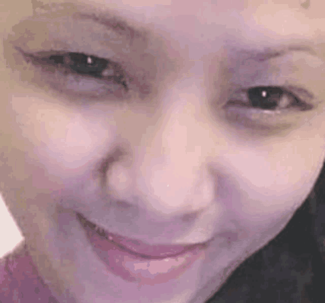 a close up of a woman 's face with a smile .