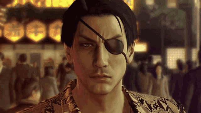 a man wearing an eye patch looks at the camera with a crowd in the background
