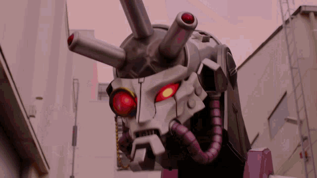 a robot with red eyes and a purple tube around its neck