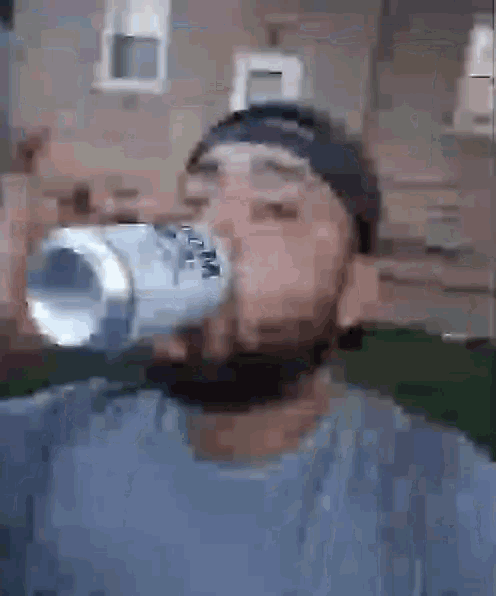 a man is drinking from a bottle that says bud light on it