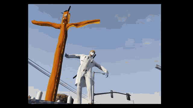a statue of a doctor with a stethoscope is standing next to a large orange balloon with a face on it