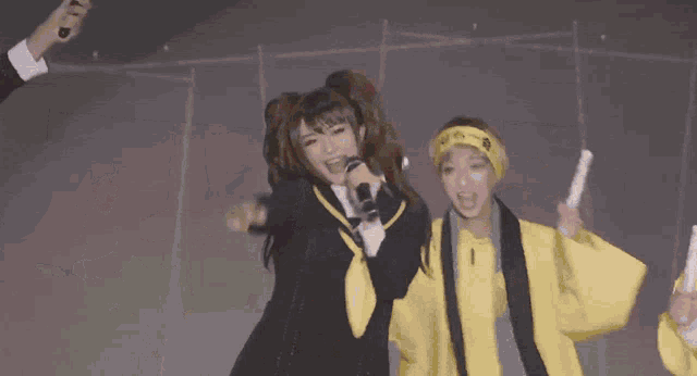 a group of people wearing yellow jackets with chinese writing on the backs