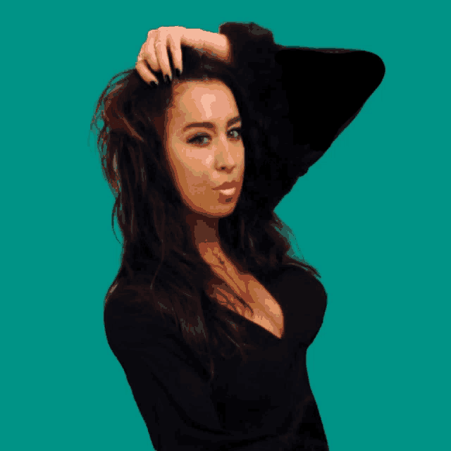 a woman in a black top holds her hair in her hand