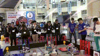 a group of people standing in front of a sign that says 2018 first ftc