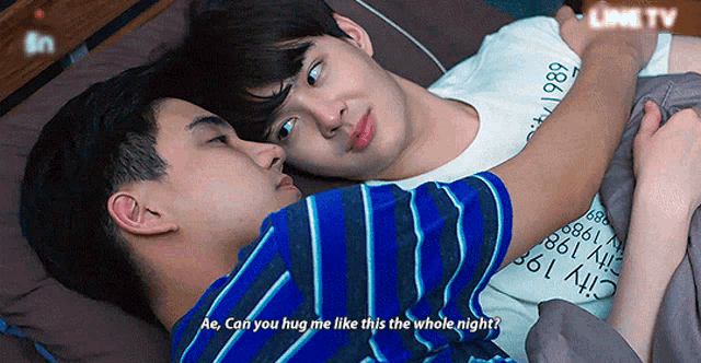 two men are hugging each other and one of them is wearing a shirt that says city 1986