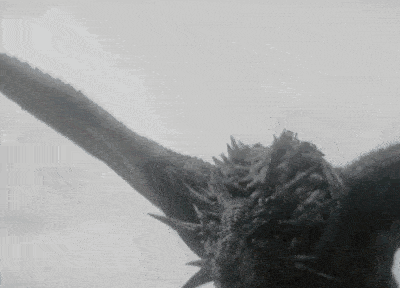 a close up of a dragon flying in the air .