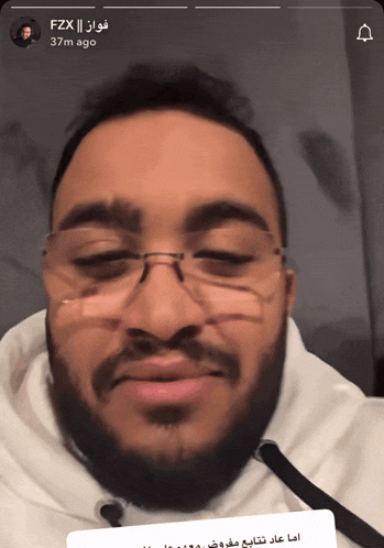a close up of a man 's face with glasses and the words fzx on the bottom right