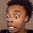 a close up of a person 's face with a surprised look on it .
