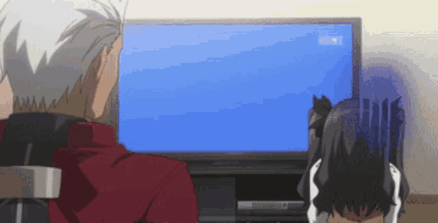 a man and a woman are sitting in front of a flat screen television