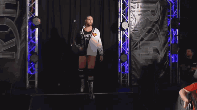 a wrestler wearing a black and white jacket that says echti pir on it