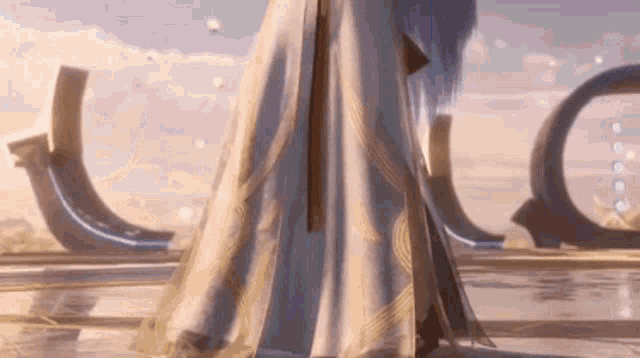 a woman in a long white dress is standing in front of a circle .